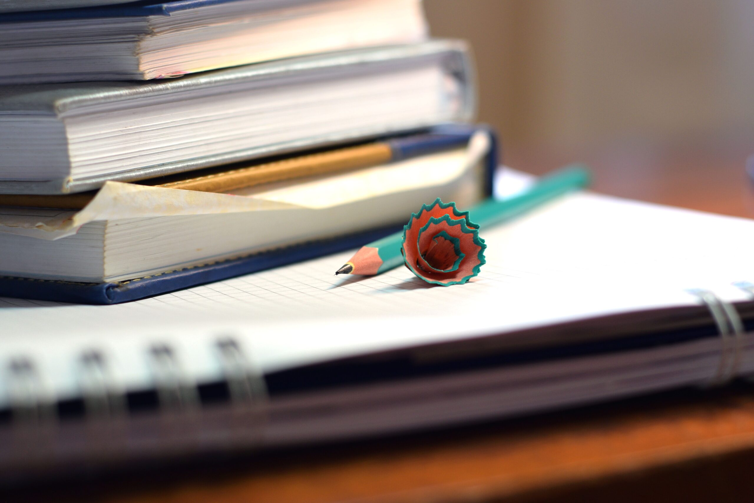Close-up of books and sharpened pencil on a desk in São Paulo, ideal for educational content.